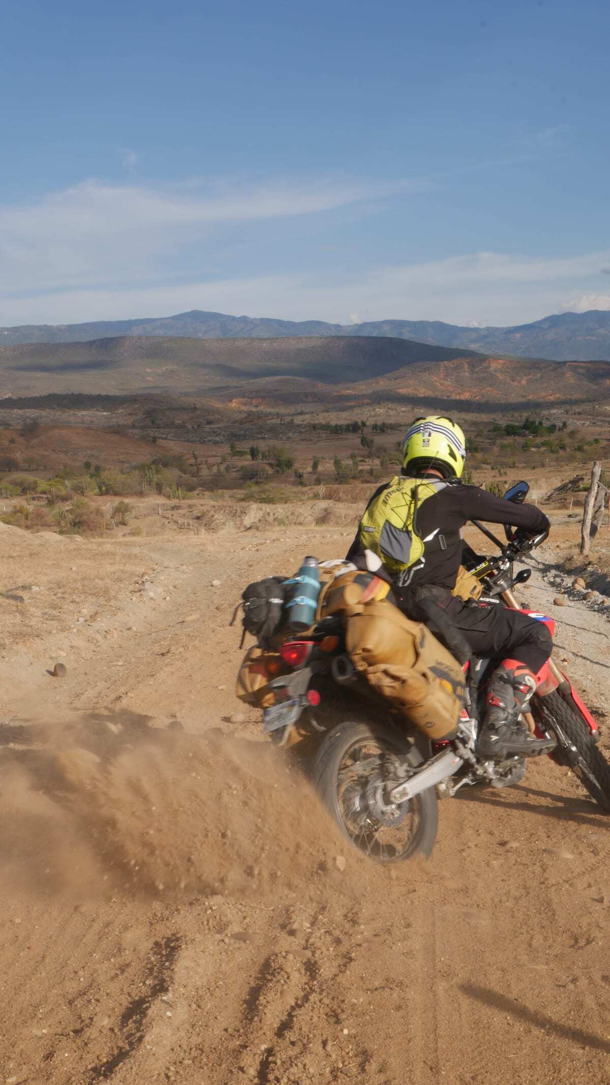 A motorcycle rear wheel throwing up dirt