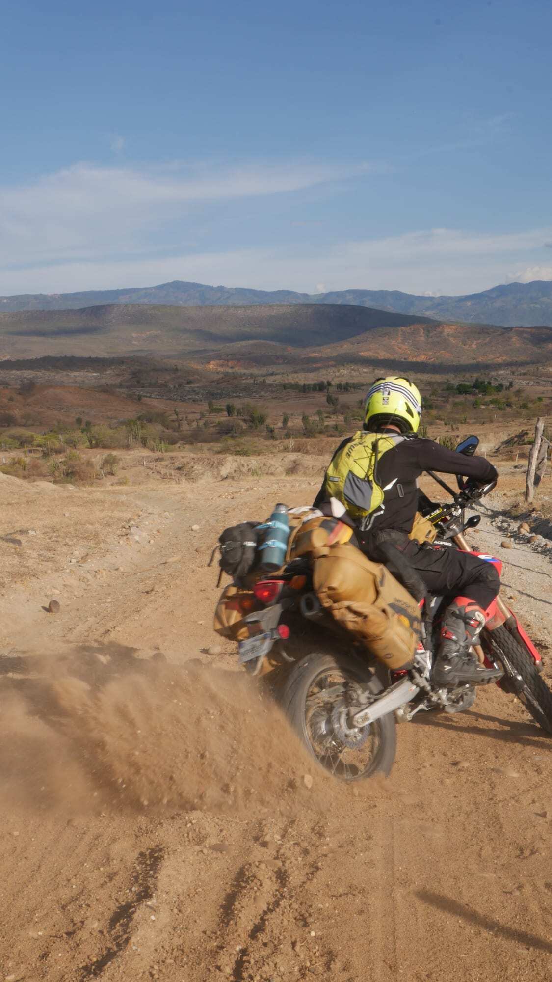 Riding a motorcycle along a dusty track