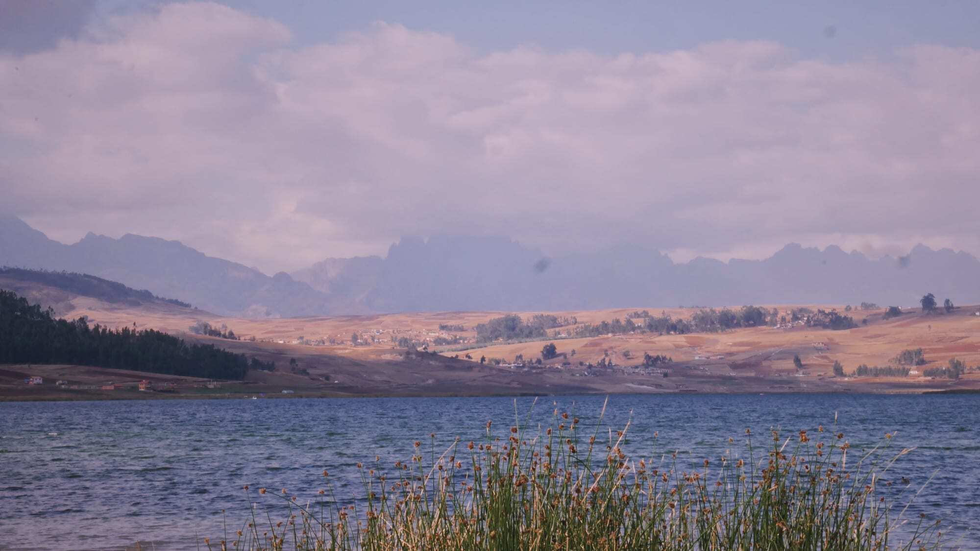 An alpine lake below distant mountains in Peru